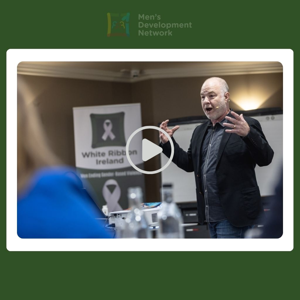 A guest speaker delivering a talk on masculinity and gender equality, representing video resources available through the Men’s Development Network.